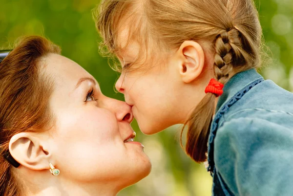Girl kisses mum on nose — Stock Photo, Image