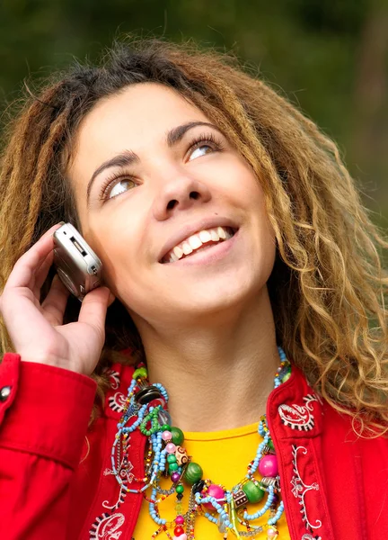 Girl with dreadlocks speaks by phone