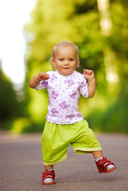 Child walks on road clipart