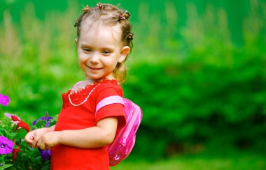 Girl with a backpack about florets clipart