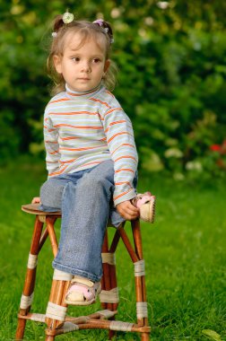 Girl sits on stool clipart