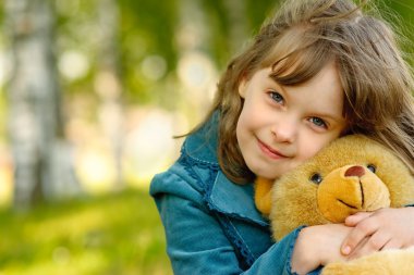 Child with toy bear cub clipart