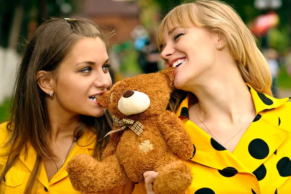 Girlfriends with toy bear cub — Stock Photo, Image