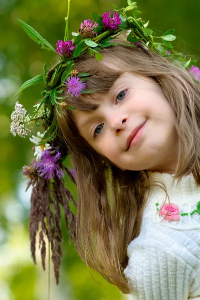 Girl with wreath smiles — Stock Photo, Image