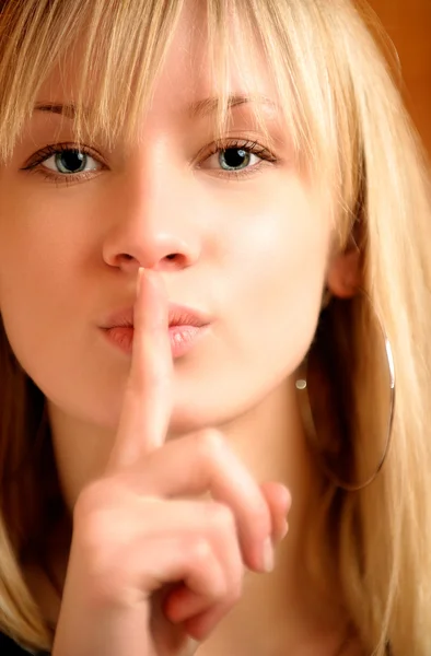 Blonde has put finger to lips — Stock Photo, Image