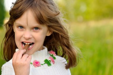 Girl eats chocolate clipart