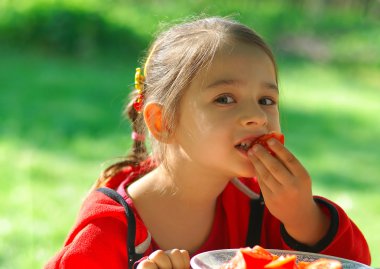 Girl bites tomato clipart