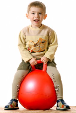 Boy on red sphere clipart