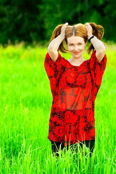 Young woman holds hair — Stock Photo, Image