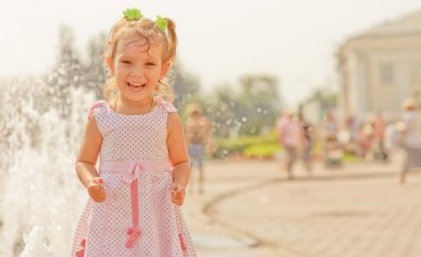 Laughing girl at fountain clipart