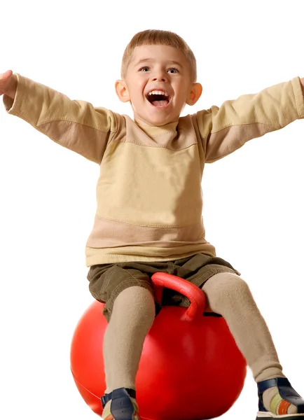 Boy on red sphere — Stock Photo, Image