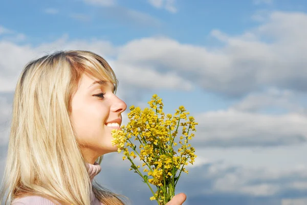 stock image Woman smells a yellow bunch