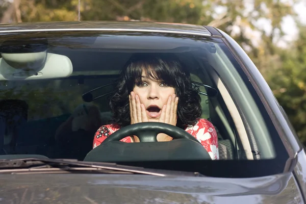 Scared woman in a car — Stock Photo, Image
