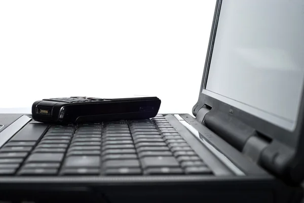 Mobile phone on a laptop — Stock Photo, Image