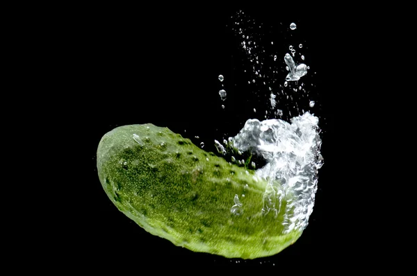 Cucumber in water on black — Stock Photo, Image