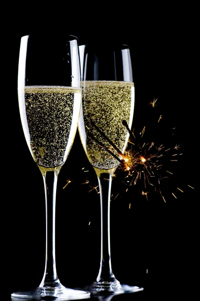 Champagne and sparkles on black — Stock Photo, Image