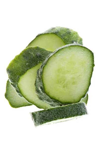 Cut cucumber in water macro — Stock Photo, Image