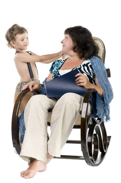 Stock image Woman reading magazine and son