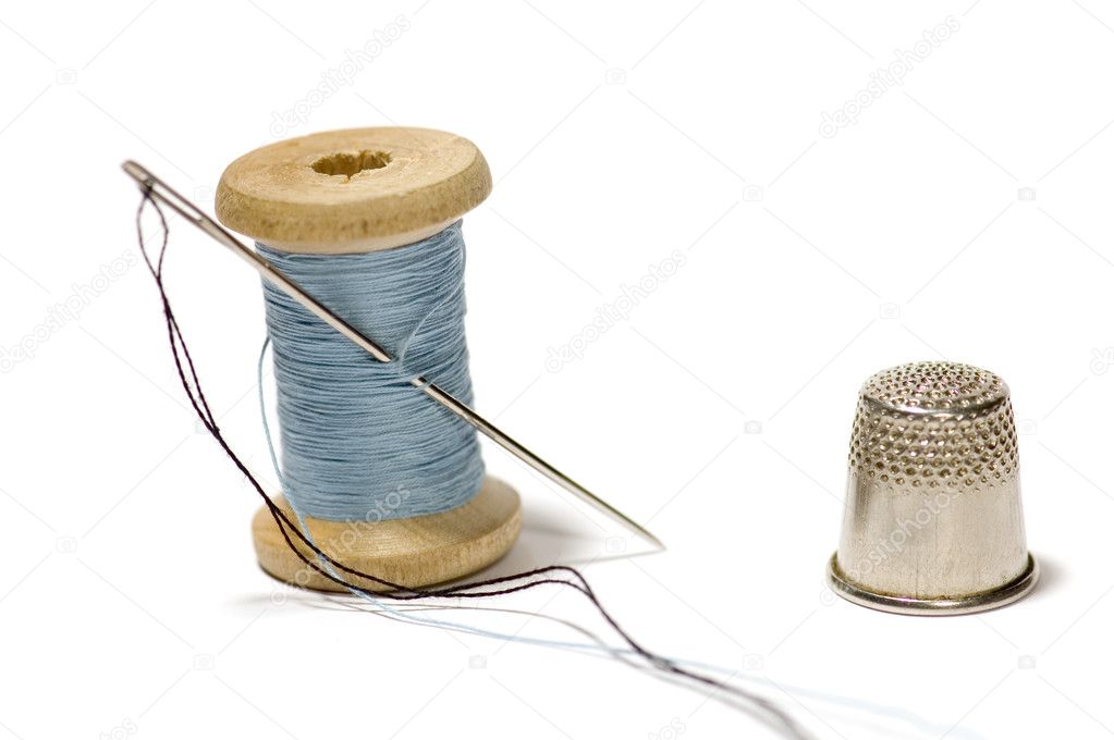 Premium Photo  A spool of blue thread with a needle and a thimble sewing  workshop atelier