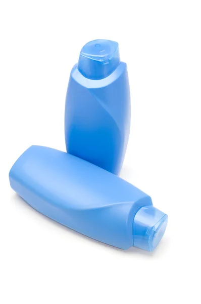 Due bottiglia blu su bianco — Foto Stock