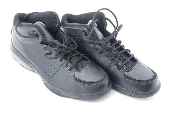 Zapatos deportivos negros en blanco — Foto de Stock