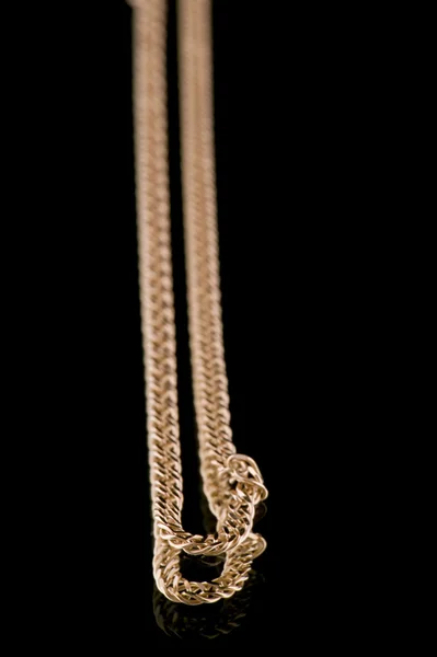 Golden chain on black closeup — Stock Photo, Image