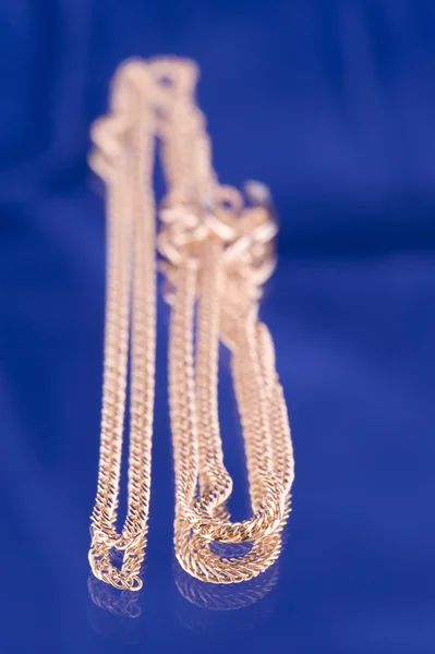 Golden chain on blue — Zdjęcie stockowe
