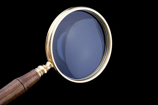 Magnifying glass on black closeup — Stock Photo, Image
