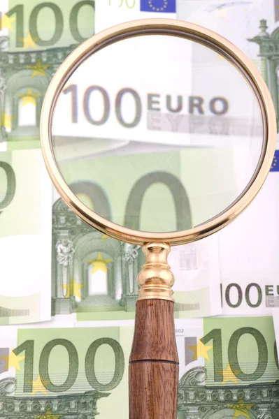 Magnifying glass with money macro — Stock Photo, Image