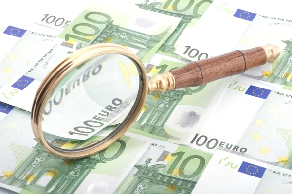 Magnifying glass with money closeup — Stock Photo, Image