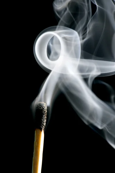 Match with smoke on black — Stock Photo, Image
