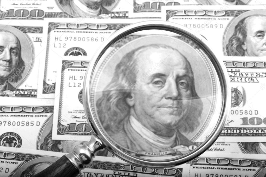 Magnifier with money closeup