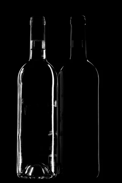 Duas garrafas de vinho em preto — Fotografia de Stock