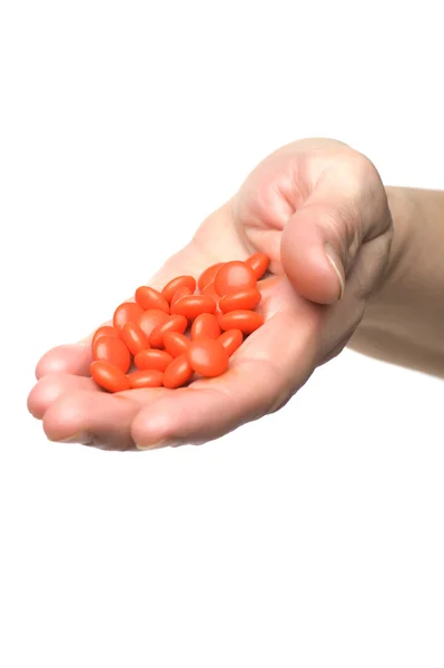 Tabletten in der Hand auf weiß — Stockfoto
