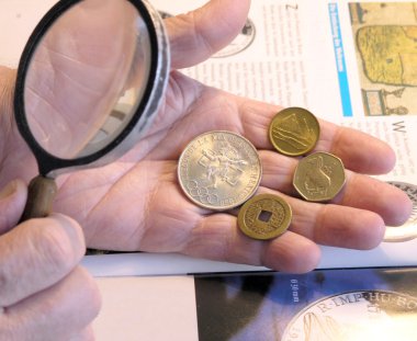 Old numismatist`s hands clipart