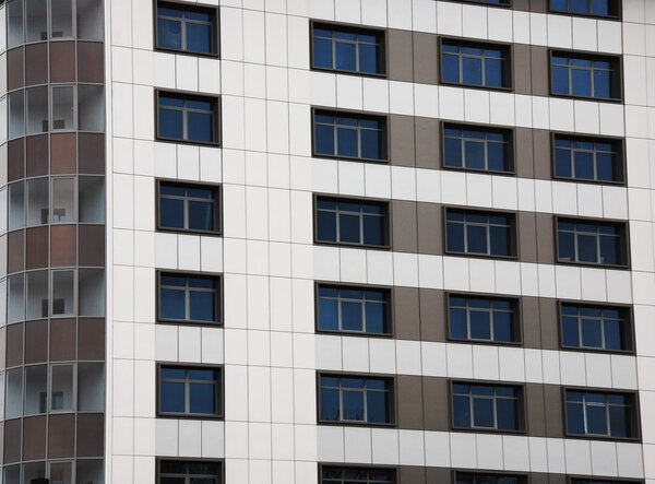 Windows of a big grey block tenement house