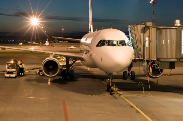 Plane parked at the airport at night