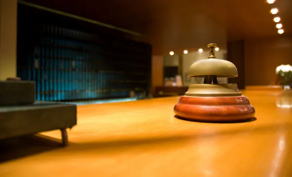 Brass bell on hotel reception — Stock Photo, Image