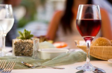 Served table with red wine at restaurant clipart