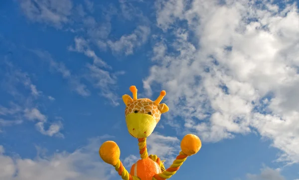 Giraffe toy over the blue sky — Stock Photo, Image