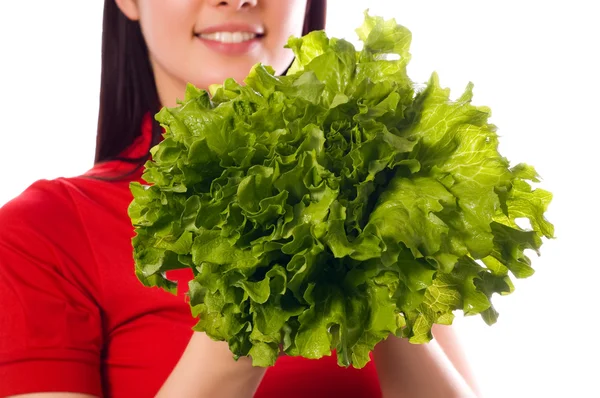 Girl is holding aleaf of salad — Stock Photo, Image
