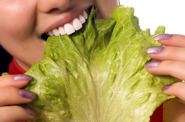 Stäng upp flicka äter en sallad blad — Stockfoto