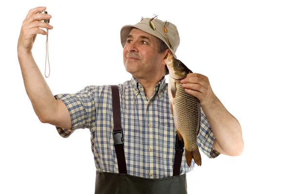 Senior Fischer mit seinem Fang — Stockfoto