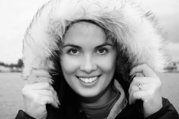 stock image Beautiful, smiling young woman with a fur hood.