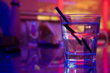 Glass of alcohol drink in the night club