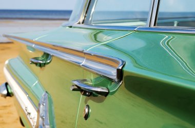 Classic green Cadillac at beach clipart