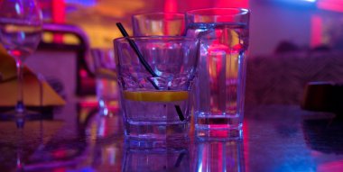 Glass of alcohol drink in the night club clipart