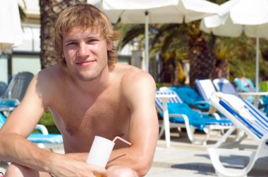 Man sitting on a deckchair sunbathing clipart