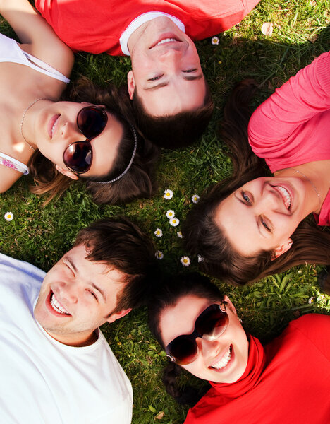 Group of friends lying on grass