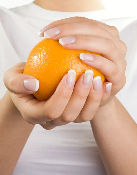 stock image Orange in woman's hands